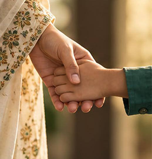 Parent holding a child’s hand